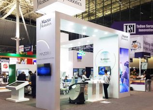 Innovative exhibition booth showcasing Mazor Robotics at a trade show.