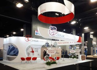 Modern exhibition booth with circular structures and branding elements.