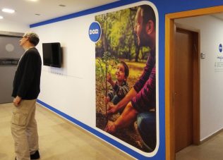 Exhibition space with large photo display and visitor viewing.