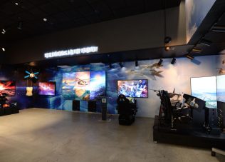 Modern exhibition space with immersive digital displays and interactive setups.